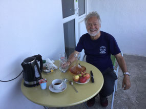Our guest house host brings us wine for breakfast
