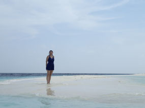 Blue clothed beauty on a seascape of blue