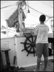 Little Brazillian boy steering the boat!