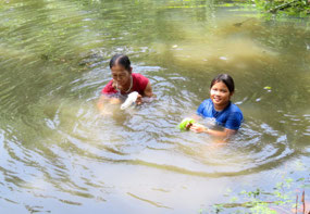 Mother and daughter collecting shellfish