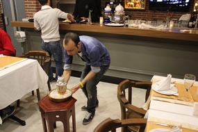 Bringing the clay pot of food