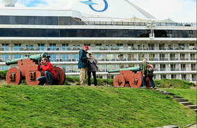 Cruise ship moored beside festning