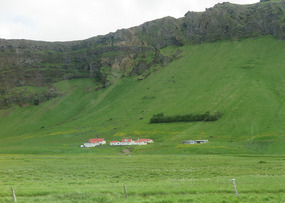 Houses look tiny beside mountains