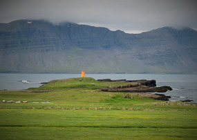 Little orange lighthouse on the fjord