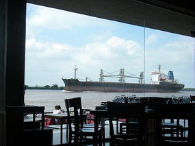 A boat goes past the cafe!