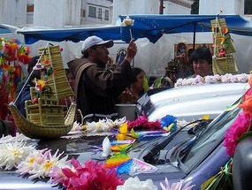 Priest blessing the car