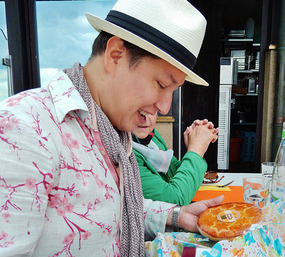 Oli opens his gift of favorite cakes from Brig