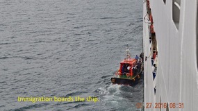 LOCAL PILOT JUMPS ON BOARD TO GUIDE US INTO PORT