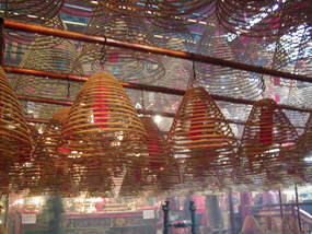 Coils of insence hang from the ceiling