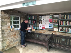 Picking his library book.