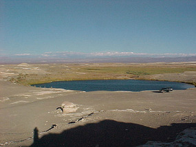 Small round lake in the middle of the desert