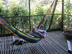Roger relaxing on our porch at Maya Mountain Lodge