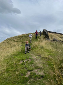 How does someone with a sore knee get down a hill?