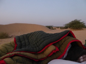 Heather huddles under mountain of heavy blankets