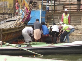 Dragging dead cow into the Ganges