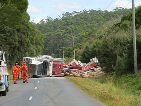 Log truck on its side