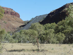 see hard dark stuff- tailings  dam overflows