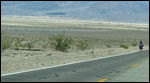 A lone bicyclist going uphill to 5,000 feet