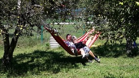 PAM AND MILES RELAXING IN THE APPLE ORCHARD