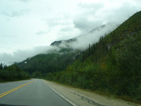 Clouds pocketed in between mountains