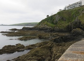 Rocky slate stone cliffs jutting out to sea 