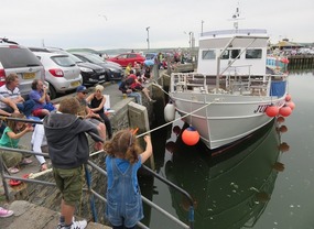 Kids catching crabs on wharf