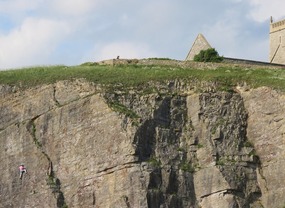 Guy climbing side of cliff