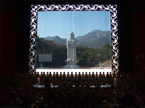 Statue seen thru Window behind Shrine