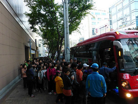 Crowds Board Shuttle Buses