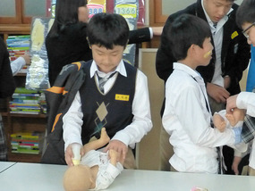 Boys Feeding Baby