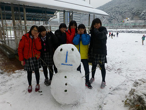 Schoolgirls Build Snowman