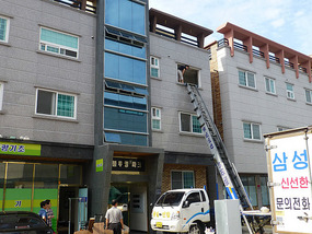 Superhero Landlady Climbs Out Window Frame