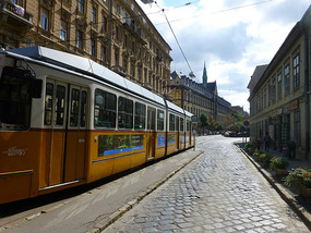 Tram and Cobbled Street
