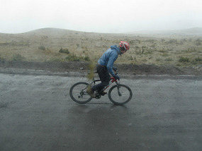 On his bike going fast