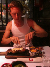 Tucking into his steak