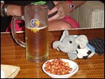 Phnom Phen - the wee man is lovin his peanuts