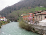 Crossing Castelnovo's river turrite on market day