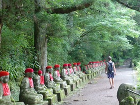 Michael walks past row of Jizo statues