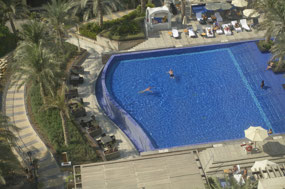 Michael swimming in the hotel pool, Doha