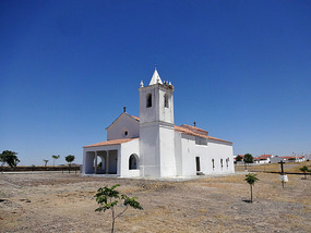 Rebuilt Aldeia da Luz behind village church