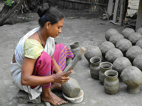 Woman Pounding the Pots into Shape