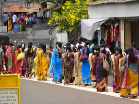Sari clad women waiting to get in the temple