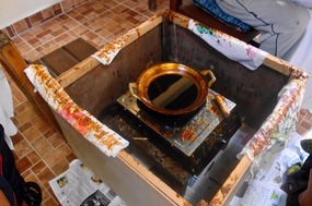 Wax heated in the wok will cover a traced pattern