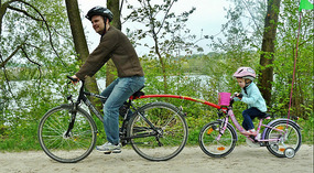 Dad with Daughter on a tow bar