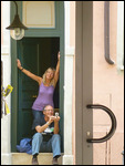 Sitting in the doorway.