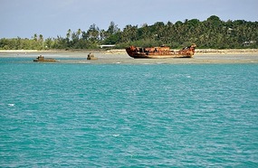 Rusting hulk on a reef in the harbor
