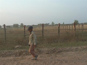 A young boy finishing work in the fields..