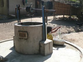 Minority Village Well & young girl washing