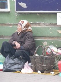 Old lady sitting in the street