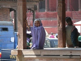Old lady protecting her temple..